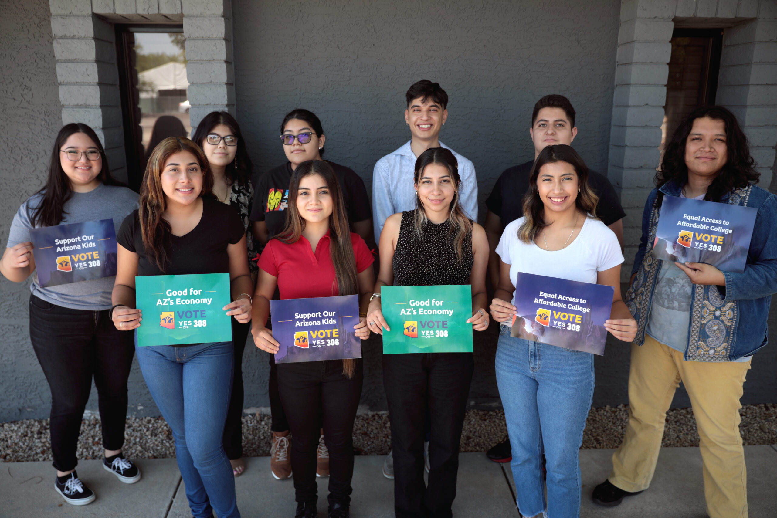 Arizona dreamers holding signs in support of Prop 308